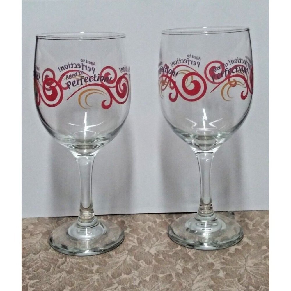 VTG Aged To Perfection Wine Glasses Set of 2 clear glass,red and yellow design